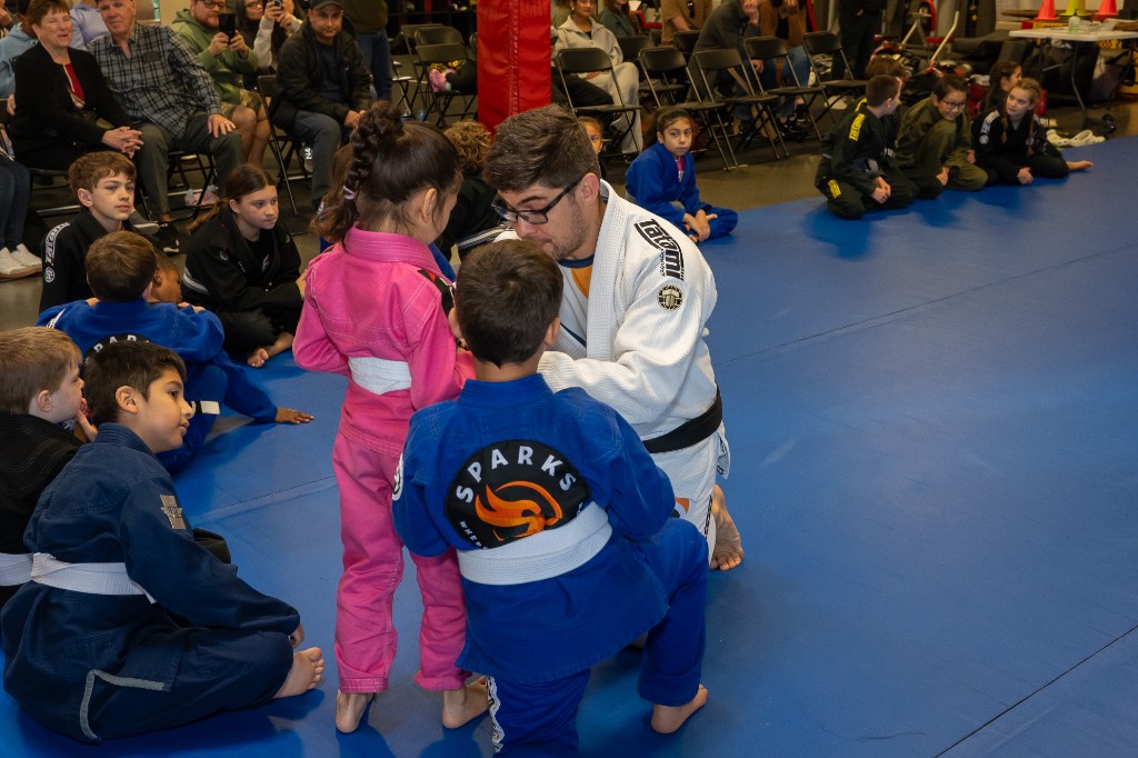Instructor Samuel teaching kids on the mats